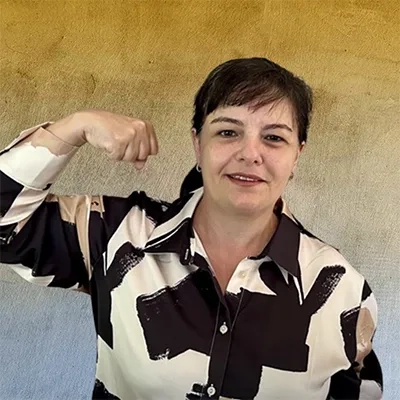 Gabriella Soares , Protiviti Australia iGroww Women’s Network Lead striking the International Women's Day 2025 Accelerating Action pose